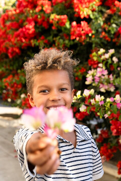 boy handing out flowers 
