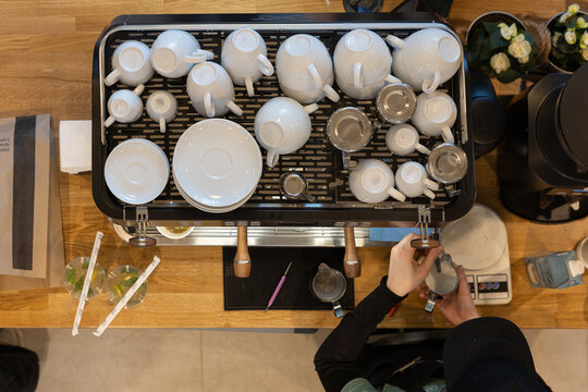 Professional barista preparing coffee with espresso machine top view