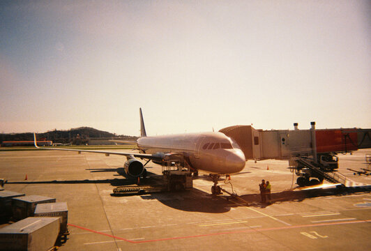 Film Photo of Passenger Airplane on Airport Tarmac in Warm Light