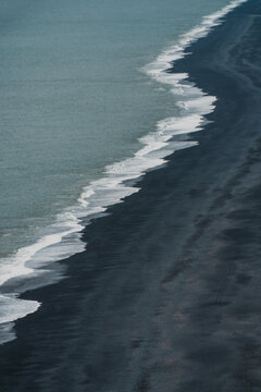 Waves crashing on black sand beach in Iceland 