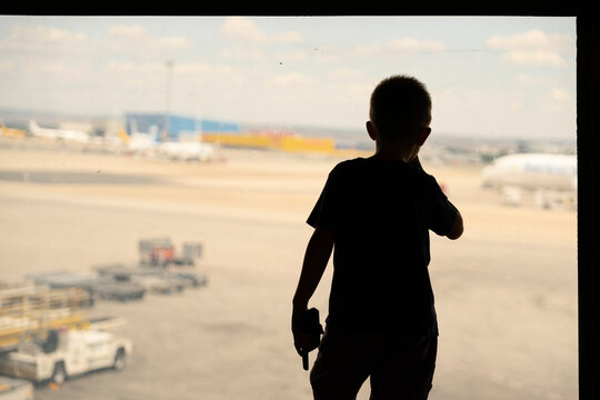 Kid looking out of the airport window