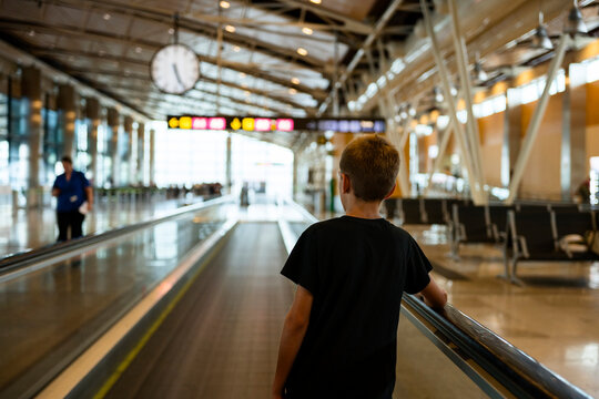 kid on moving walkway at an airport