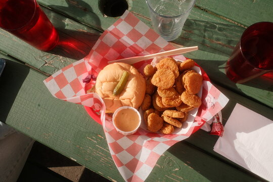 Ideal Picnic Meal With Chicken Nuggets and Sandwich on a Table