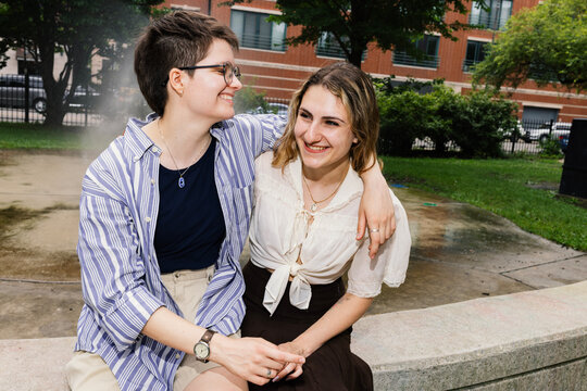 Lesbian Couple laughing at Park Fountain