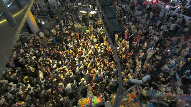 14 Aril 2026, Dynamic aerial footage capturing the vibrant atmosphere of the Songkran Festival along Silom Road in Bangkok, Thailand. Large crowds gather to celebrate with water guns