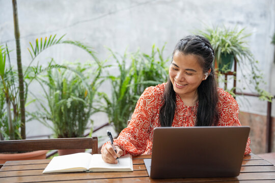 A woman working and taking notes