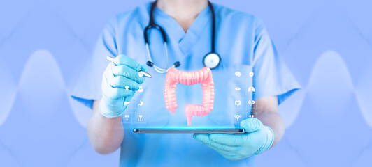 Fototapeta premium Concept of telemedicine and digital monitoring of the digestive system, early detection and screening of colon cancer. Gut health and modern medicine. Doctor using a tablet examines the colon.