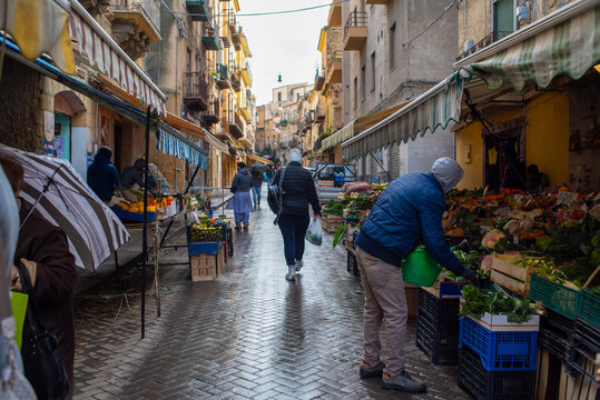 Busy Market Street Bustling With Shoppers and Vendors During Daytime