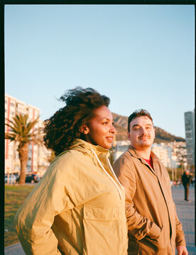 Couple taking a sunset stroll by the seaside