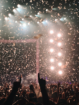 Confetti swirling with spotlights at live performance