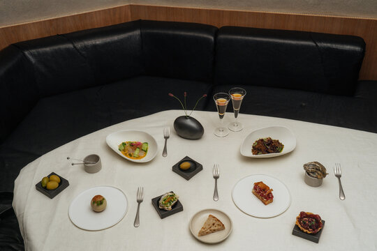 Gourmet Tasting Menu on White Tablecloth in Elegant Setting