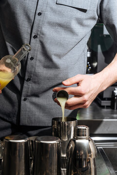 Bartender Pouring Juice into Cocktail Shaker 