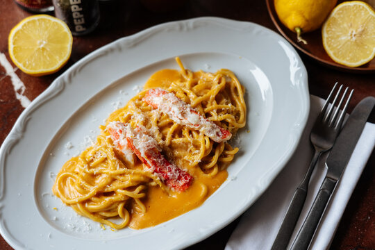 Lobster Pasta with Cream Sauce and Parmesan on White Plate