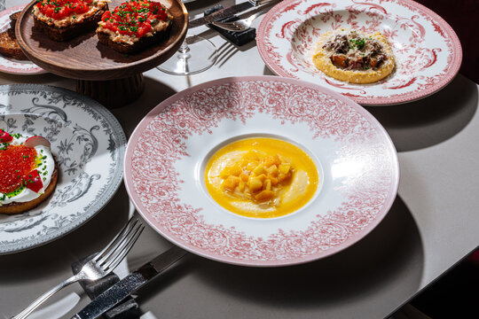 Elegant dining table with gourmet dishes and wine
