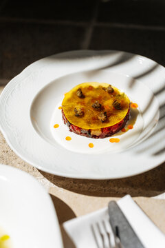 Gourmet layered appetizer with jelly topping and cream sauce