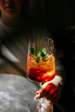 Refreshing iced cocktail with mint garnish in wine glass