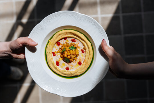 Plate of hummus with chickpeas and garnish