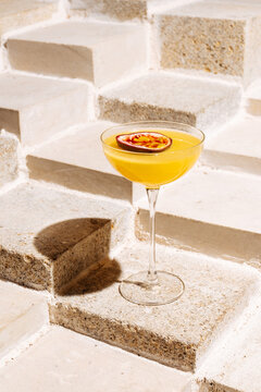 Passion fruit cocktail on stone steps 