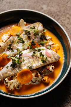 Fish fillet with roasted cauliflower and carrot slices 