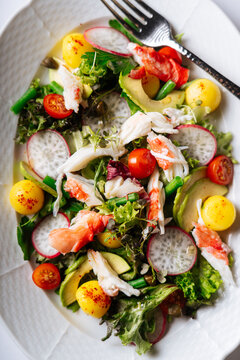 Fresh crab salad with radish and avocado