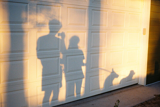 Shadows of man and woman with two dogs on the walk. shot on film 