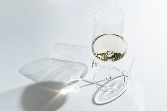 Glass of white wine with empty wine glass