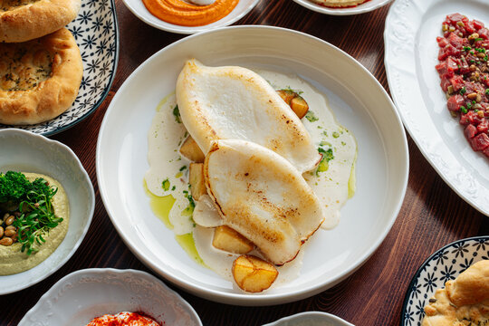 Grilled cuttlefish with cream sauce and potatoes