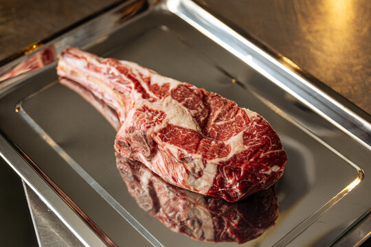 Raw Tomahawk Steak on Metal Tray