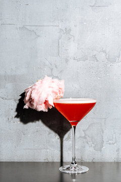 Red Cocktail with Cotton Candy Garnish