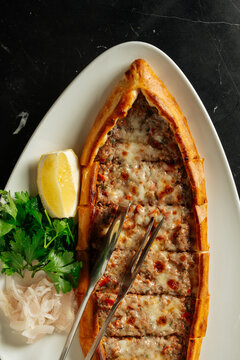 Turkish pide with minced meat and melted cheese