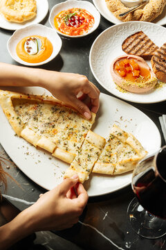 Cheese pide with herbs and assorted appetizers 