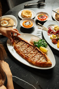 Minced meat Turkish pide served with sides