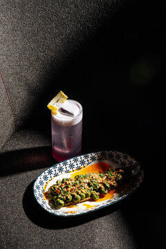 Purple Cocktail with Stuffed Eggplant Dish