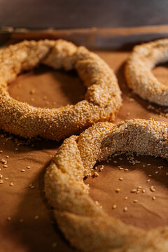 Freshly baked sesame seed rings on parchment