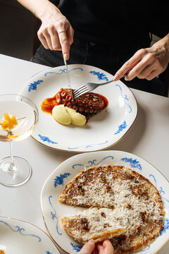 Dining scene with grilled octopus, flatbread, and cocktail 