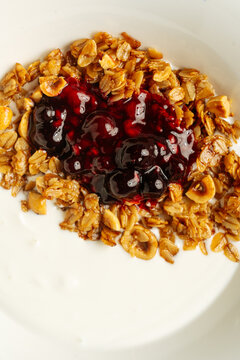 Granola with yogurt and berry jam