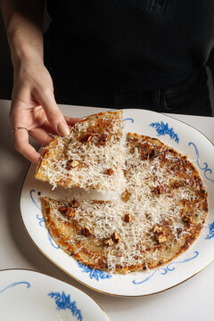 Cheese flatbread with nuts on decorative plate