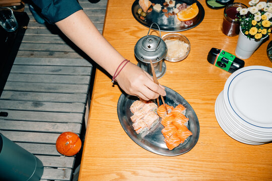Delicious Sushi Served on a Wooden Table During a Casual Gathering