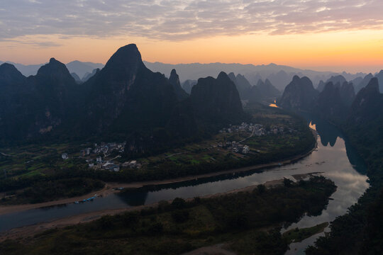 Silhouettes of karst mountains and Li River in Yangshuo, China 