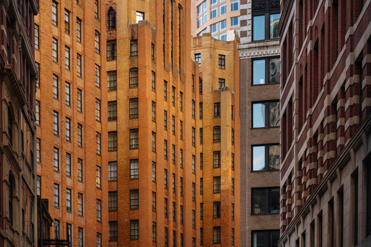  Tall brick buildings in narrow city street canyon