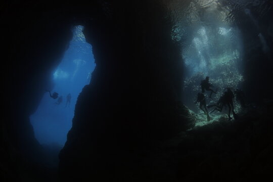 scuba divers are exploring the caves underwater
