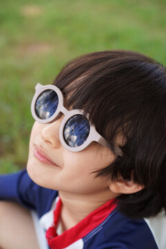 A portrait of a Chinese boy wearing cute sunglasses