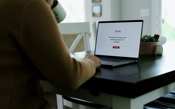 Middle Aged Man Testing Classic Dad Joke Generator Web Application - Dad Jokes On Demand Comic Relief Concept