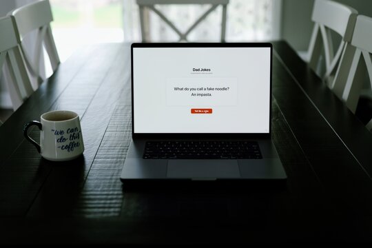 Middle Aged Man Testing Classic Dad Joke Generator Web Application - Dad Jokes On Demand Comic Relief Concept