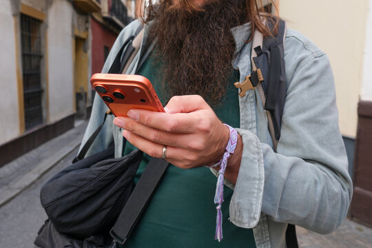Man Using Phone While Walking