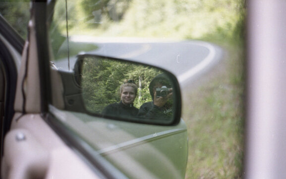 Two friend self portrait in side car mirror.