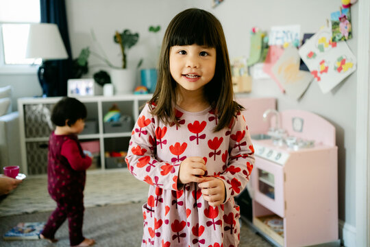 little girl standing in her play area