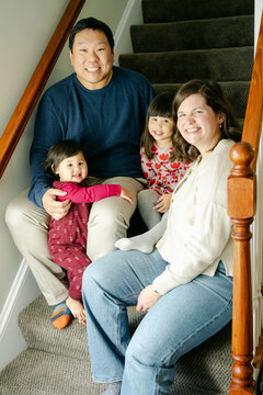 happy family of four in their home 