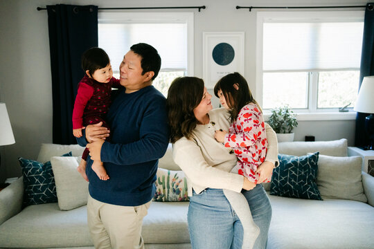 happy family of four in their home 