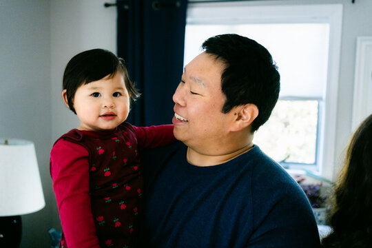 smiling father hugging his little girl 